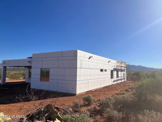 view of property exterior with a mountain view