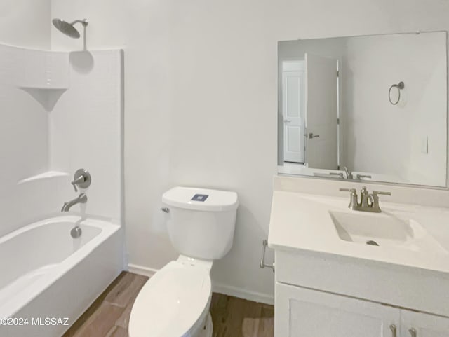 bathroom with vanity, tub / shower combination, wood finished floors, and toilet