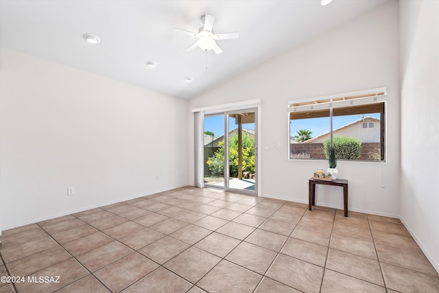 unfurnished room with vaulted ceiling, light tile patterned floors, and ceiling fan