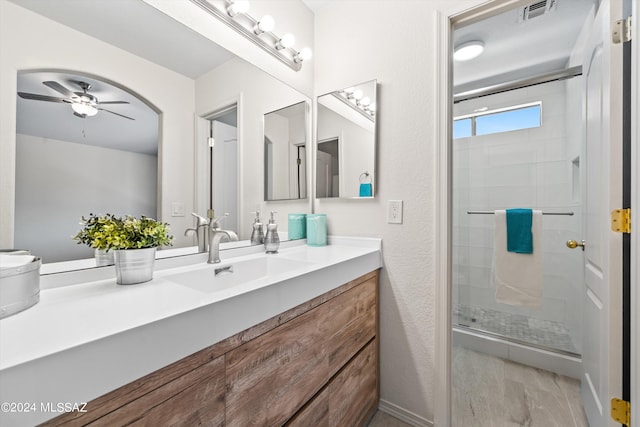 bathroom featuring vanity, hardwood / wood-style floors, an enclosed shower, and ceiling fan