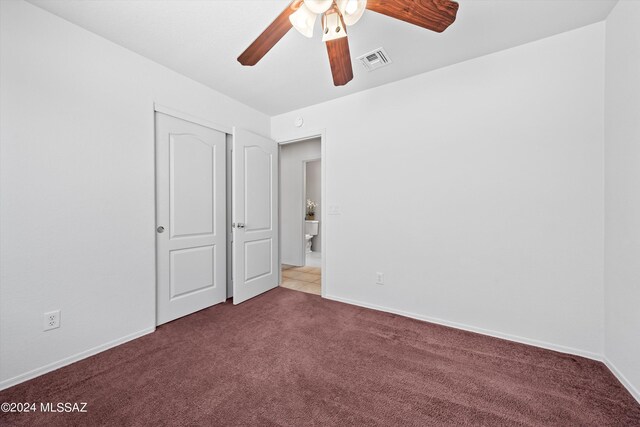 carpeted empty room featuring ceiling fan