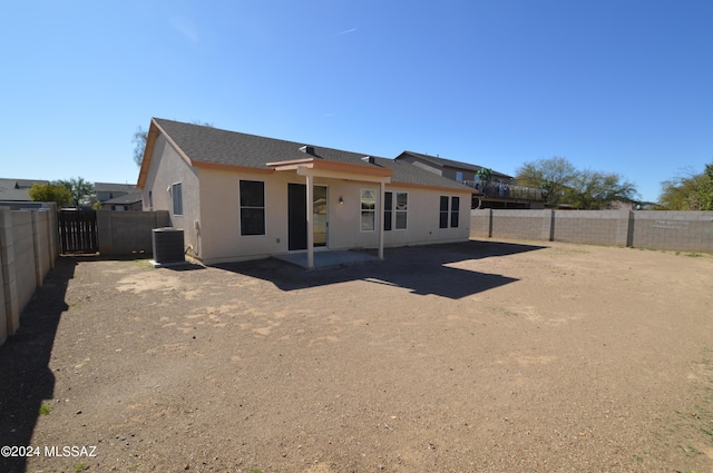 rear view of property featuring central AC unit and a patio area