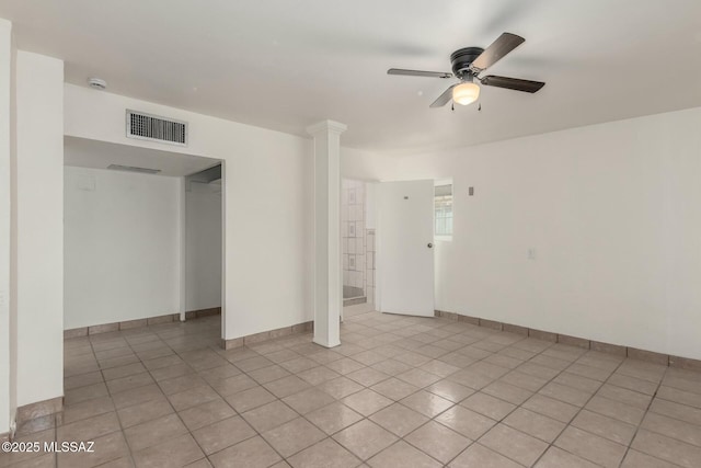 tiled empty room with decorative columns and ceiling fan