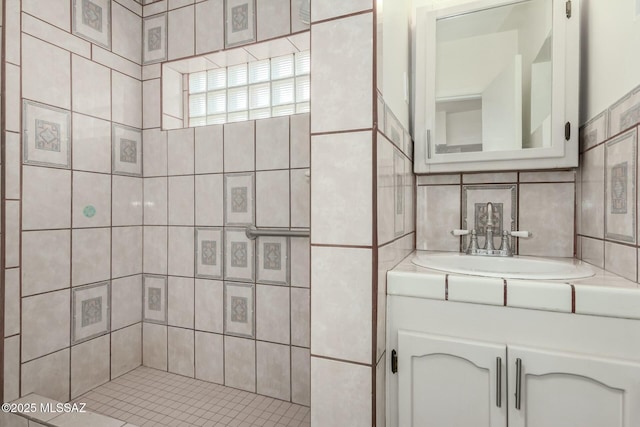 bathroom with vanity and tasteful backsplash