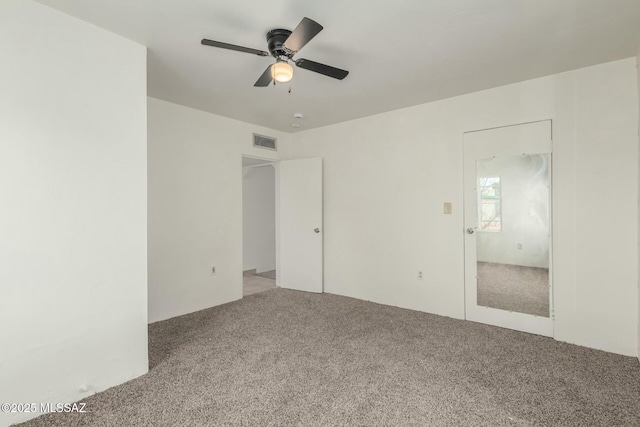 unfurnished bedroom with ceiling fan and carpet