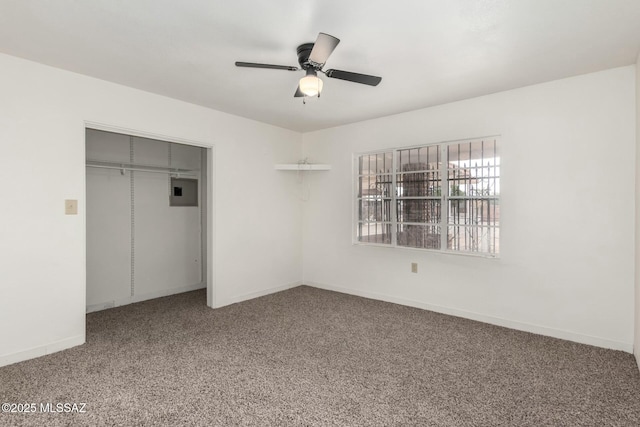 unfurnished bedroom featuring ceiling fan, carpet flooring, electric panel, and a closet