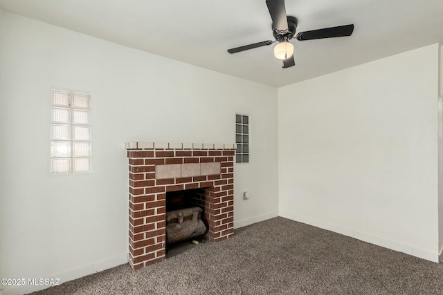 unfurnished living room featuring ceiling fan, a fireplace, and dark colored carpet