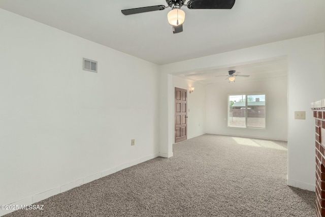 unfurnished room with ceiling fan and carpet