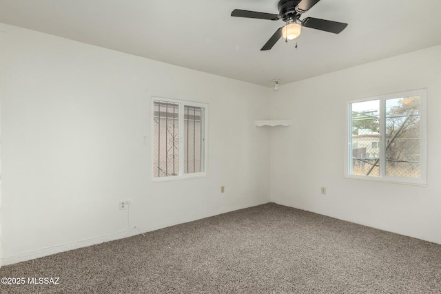 carpeted empty room featuring ceiling fan