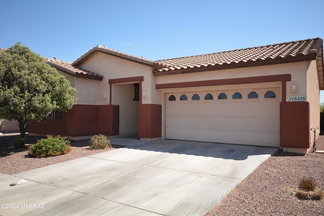 mediterranean / spanish house with a garage