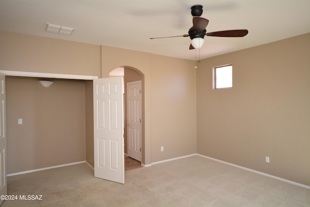 interior space featuring ceiling fan and light colored carpet