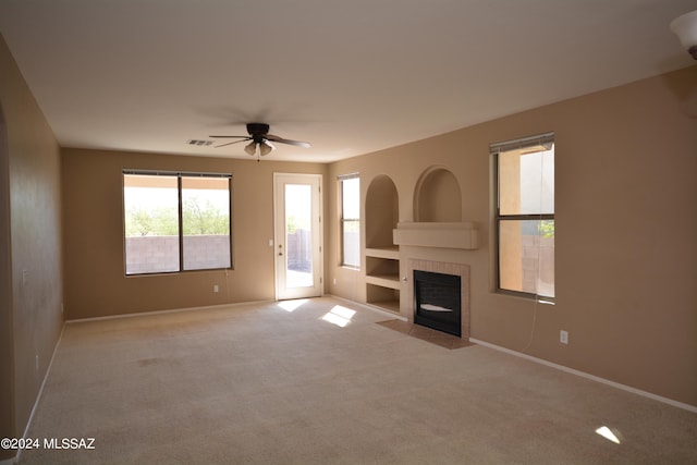 unfurnished living room featuring ceiling fan and light carpet