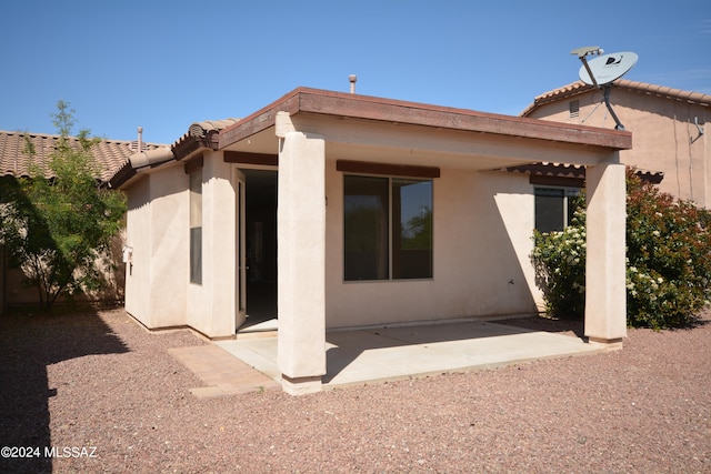 rear view of property featuring a patio area
