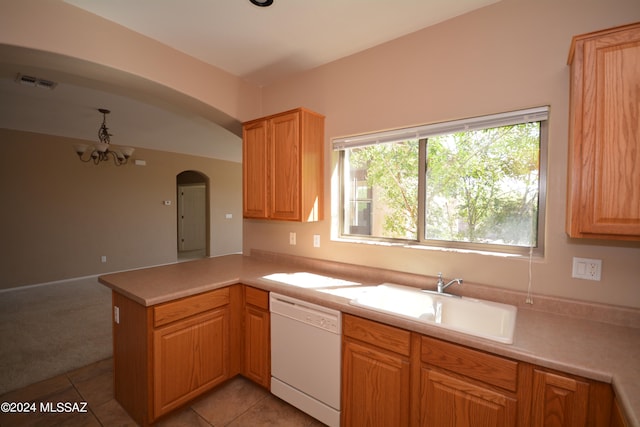 kitchen featuring light tile patterned floors, white dishwasher, an inviting chandelier, sink, and kitchen peninsula