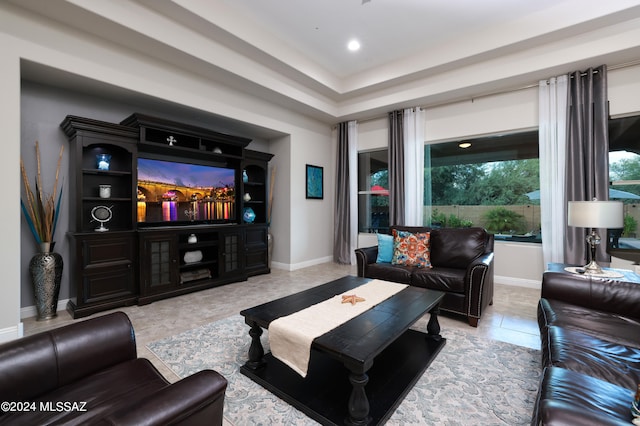 living area with tile patterned flooring and baseboards