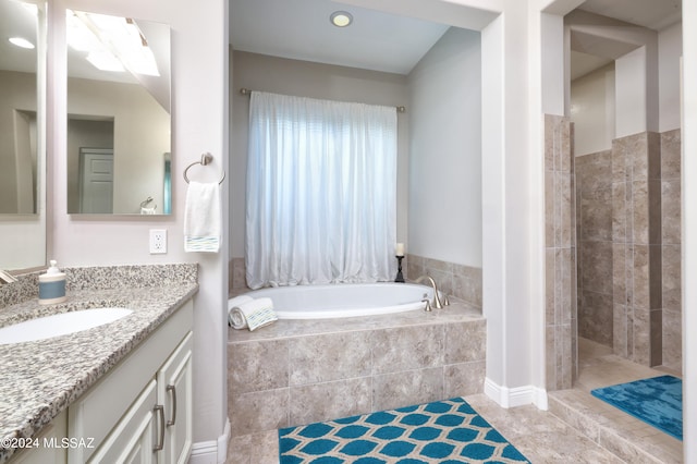 bathroom with vanity, tile patterned floors, and separate shower and tub