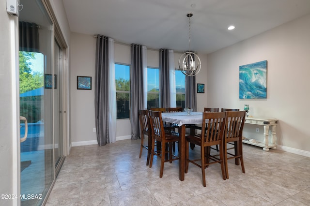 dining area with recessed lighting, baseboards, and an inviting chandelier