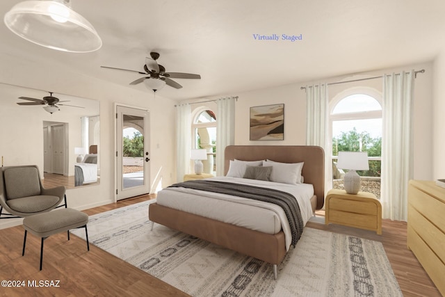 bedroom featuring multiple windows, access to exterior, light wood-type flooring, and ceiling fan