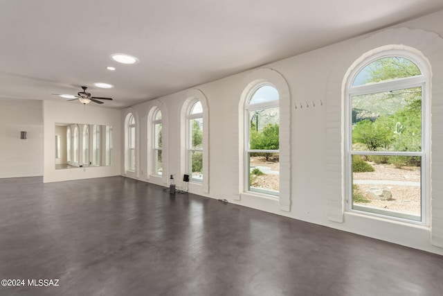 interior space with a ceiling fan, concrete flooring, and recessed lighting