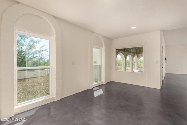 interior space with a wealth of natural light, concrete flooring, and recessed lighting