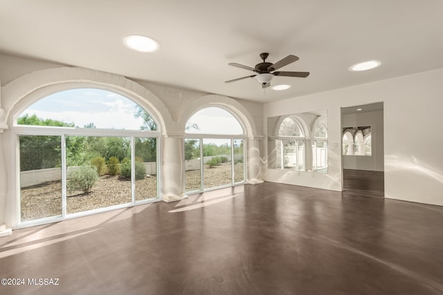 unfurnished room with concrete flooring and ceiling fan