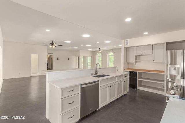 kitchen featuring appliances with stainless steel finishes, concrete flooring, a sink, and recessed lighting