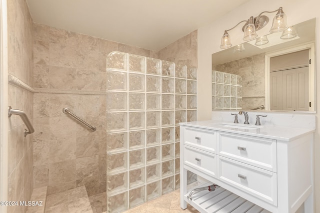 bathroom featuring tile patterned floors, a walk in shower, and vanity