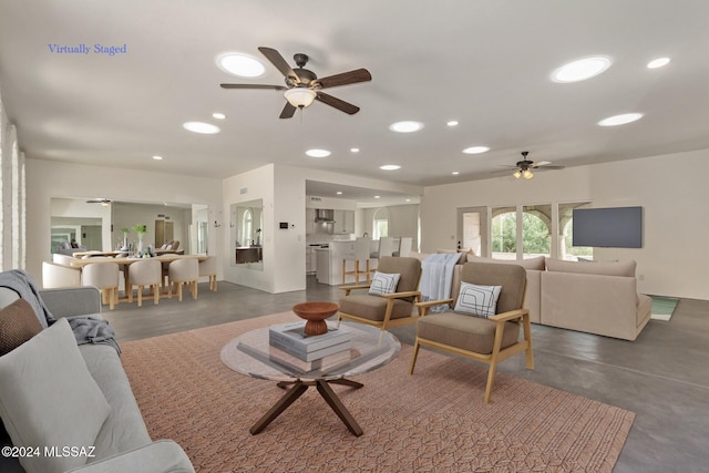 living room with recessed lighting, ceiling fan, and finished concrete flooring