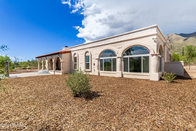 back of property featuring a patio and a mountain view