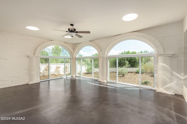 interior space featuring finished concrete floors and ceiling fan