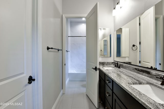 bathroom featuring tiled shower / bath combo, vanity, and tile patterned floors