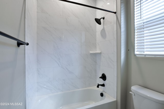 full bathroom featuring toilet, a healthy amount of sunlight, and washtub / shower combination