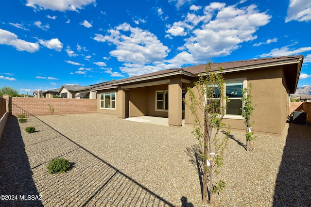 back of house featuring a patio area, a fenced backyard, and stucco siding