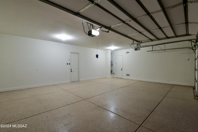 garage featuring baseboards and a garage door opener