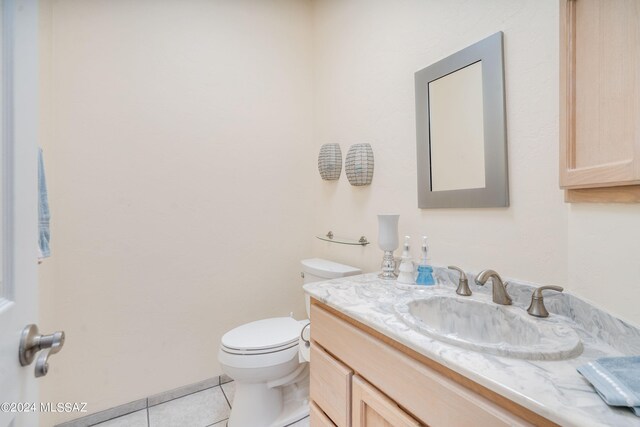 bathroom with vanity, tile patterned flooring, and toilet