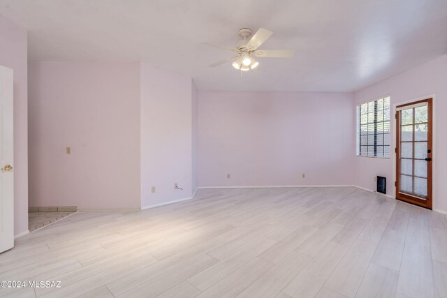 unfurnished room with light wood-type flooring and ceiling fan