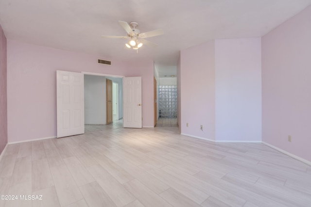 empty room featuring light hardwood / wood-style flooring and ceiling fan