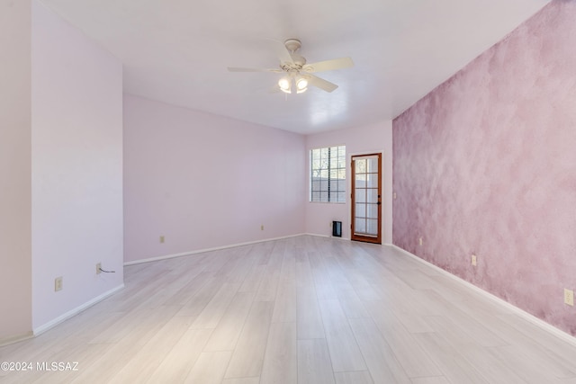 empty room with light hardwood / wood-style floors and ceiling fan