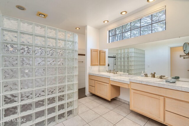 bathroom with vanity, a shower, and tile patterned flooring