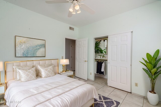 bedroom featuring light tile patterned flooring, ceiling fan, and a closet