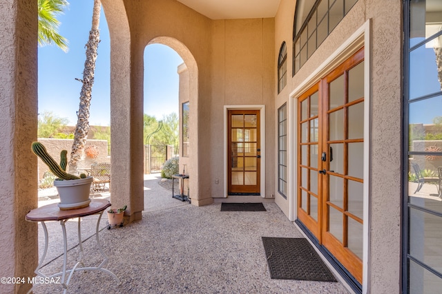 view of exterior entry with a patio and french doors