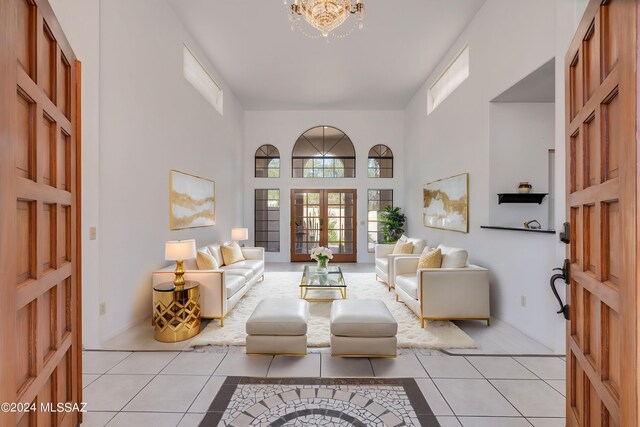 entryway featuring french doors, a notable chandelier, and light hardwood / wood-style flooring