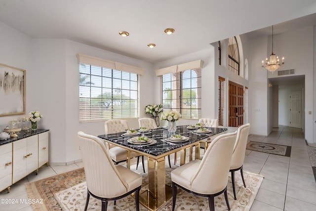 dining space featuring an inviting chandelier and light tile patterned floors