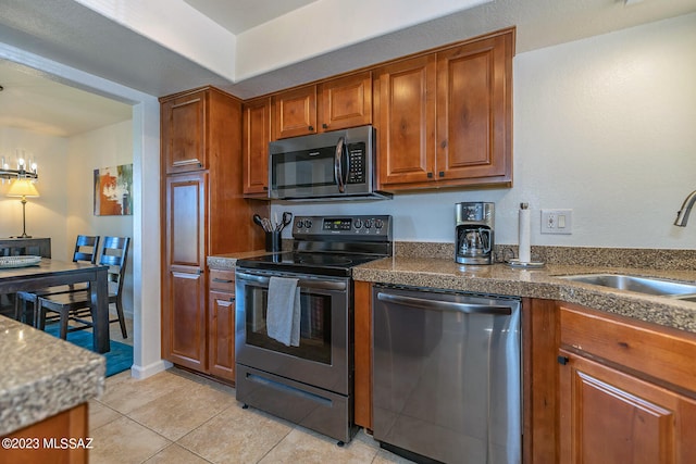 kitchen featuring sink, appliances with stainless steel finishes, and light tile patterned floors