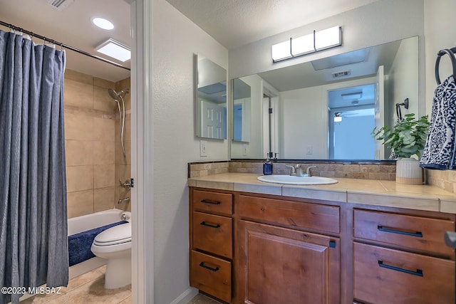 full bathroom with shower / bath combination with curtain, a textured ceiling, tile patterned floors, vanity, and toilet