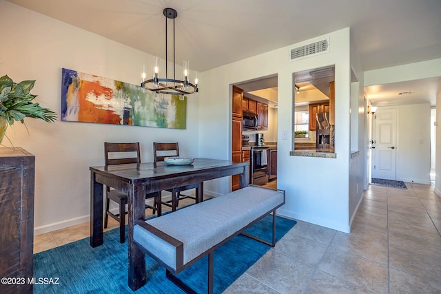 dining space with a notable chandelier and tile patterned floors