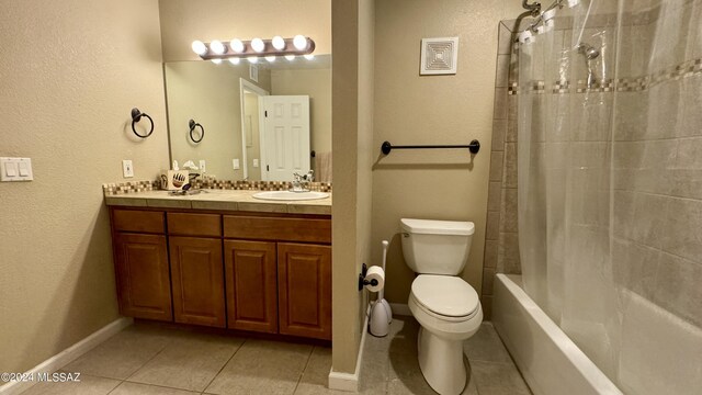 full bathroom featuring tile patterned flooring, vanity, toilet, and shower / bath combo