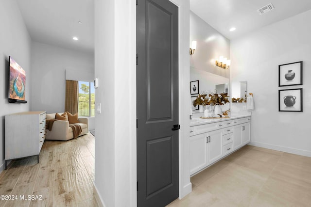 bathroom with vanity and hardwood / wood-style floors