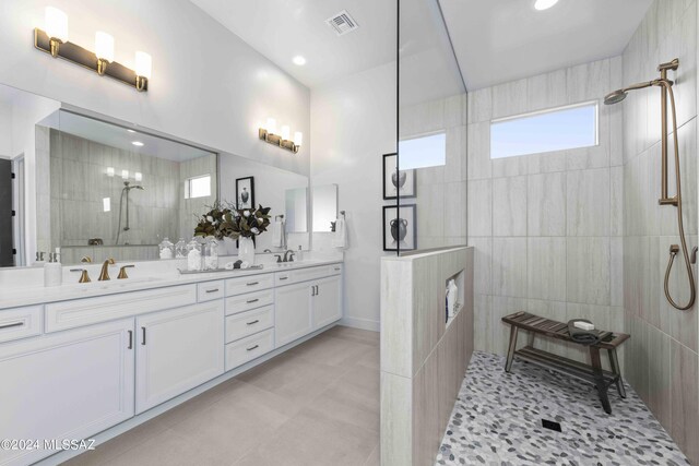 bathroom with tiled shower, tile walls, and vanity