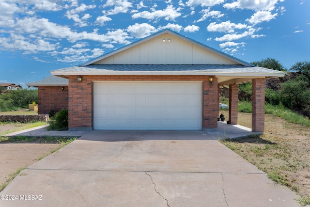 view of front of home featuring a garage, brick siding, and a shingled roof